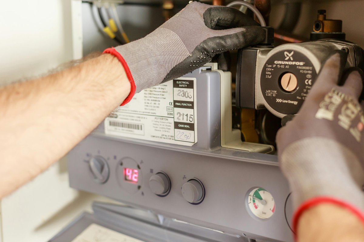 Furnace repair technician working on heating system in Avondale AZ